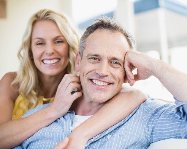 happy couple smiling with dental implants in Houston
