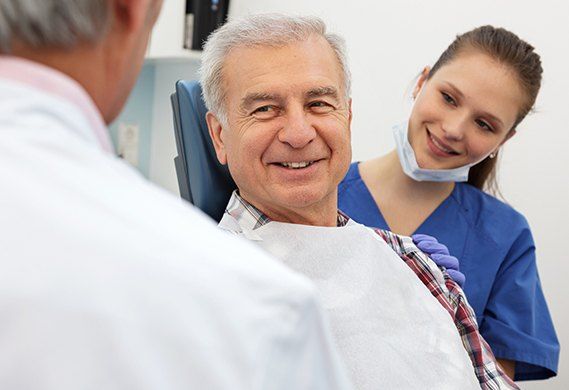 Older man smiling at dentist